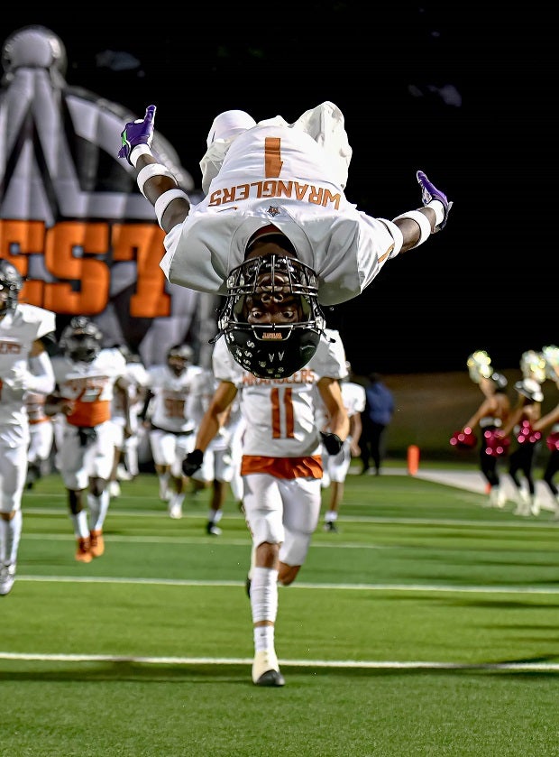 A West Mesquite flips during his entrance to the field in a November game. (Photo: Wayne Grubbs)