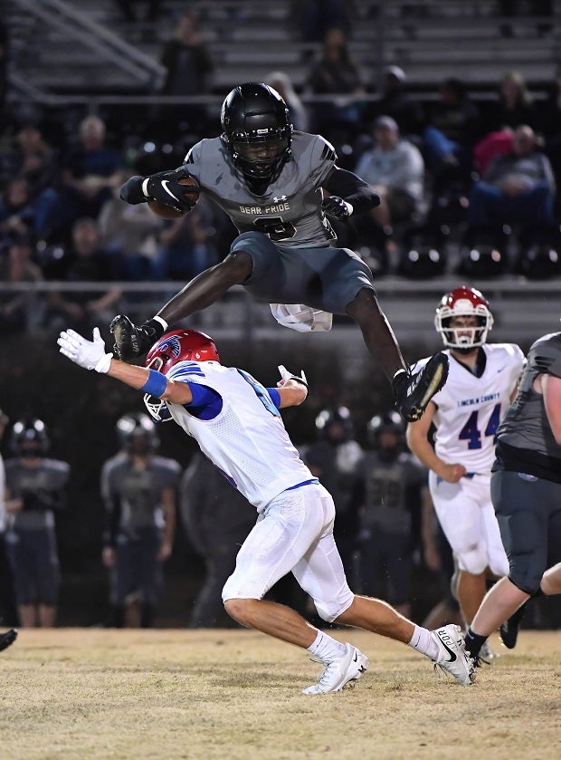Mount Juliet freshman Noah Bussinger leaps over a Lincoln County defender in a 43-6 Tennessee playoff win. (Photo: Scott Hughes)