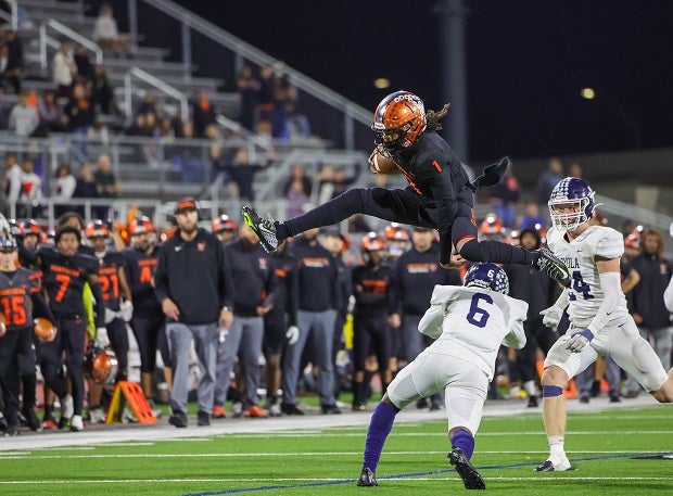 Orange quarterback Hype Grand hurdles a would-be Loyola tackler in the Panthers' 38-35 CIF Southern Section Division 6 playoff win on Nov. 18. (Photo: Paolo Polla)