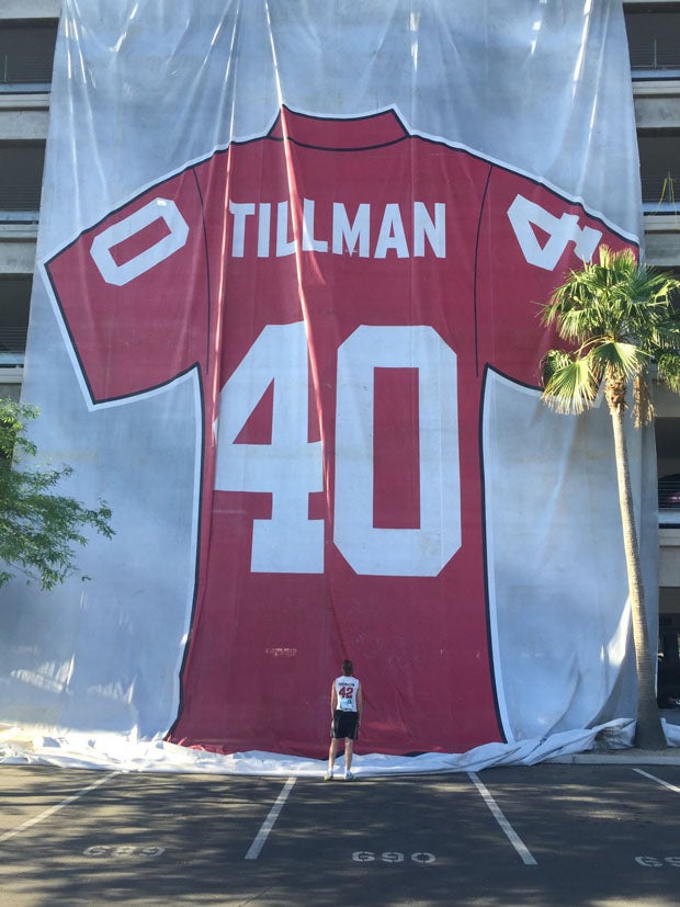 Adam Garwood looking up at a gigantic Pat Tillman jersey before an annual 4.2-mile run in Tempe (Ariz.) put on by the Pat Tillman Foundation. "Pat's Run" is the signature fundraiser for the foundation's scholarship program, this year scheduled April 24 to be run virtually. 