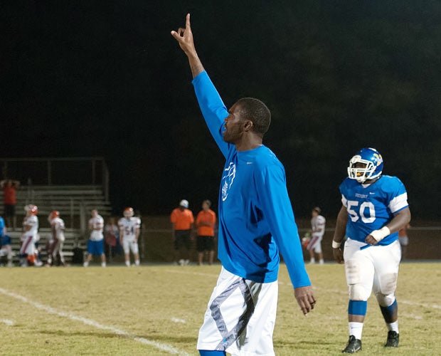 Randy Moss signals to his team during Thursday's game.