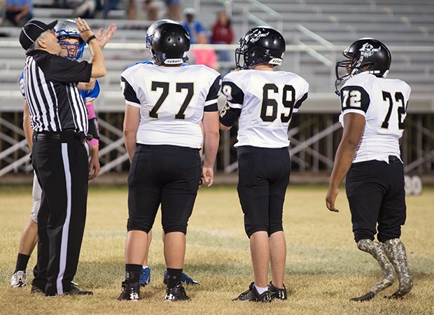 Martel joins a few teammates for the coin toss at midfield.