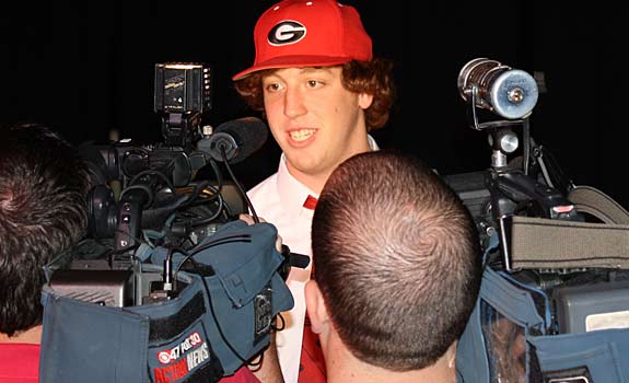 Even though he had been committed to Georgia for months, John Theus officially inking his National Letter of Intent was still a significant story in SEC country. Theus, who is swarmed by reporters here, is the nation's top offensive tackle.