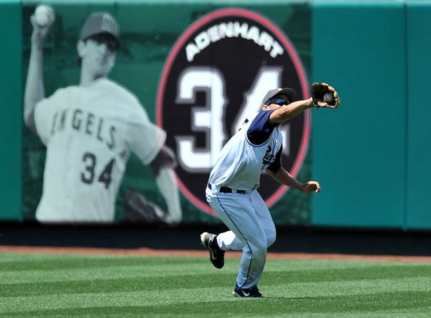 A Beckman High outfielder makes a catch in 2009 in front of a mural honoring Nick Adenhart, an Anaheim Angels pitcher who was killed by a drunk driver.