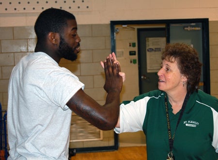 Tomir Gibbs of Mount Pleasant, left, with coach Lisa Sullivan.