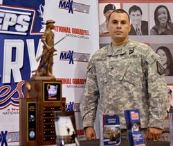 Staff Sergeant Santos of the Georgia Army
National Guard showcases the National
Guard Rivalry Trophy that goes home with
the winning team on Friday night.