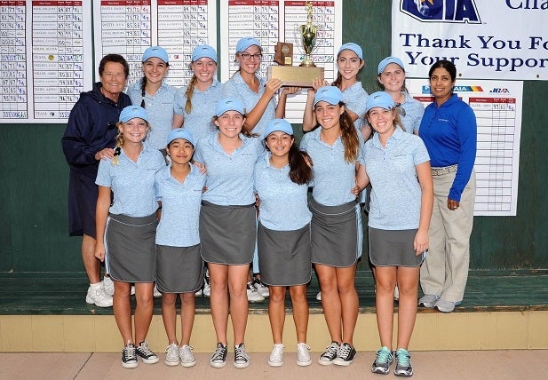 Sister Lynn Winsor (back left) poses with her Xavier College Prep golf team in 2015. She has more than 500 career wins in her career.