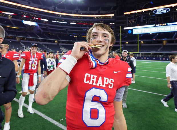 Cade Kubnik enjoys his third state title with a cookie.