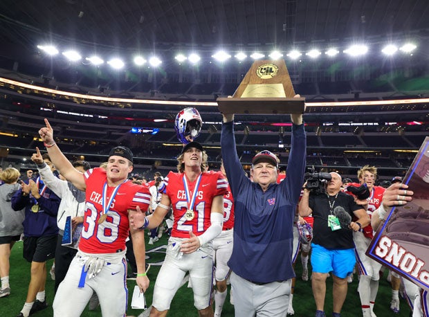 Todd Dodge holds up his seventh Texas state title trophy.