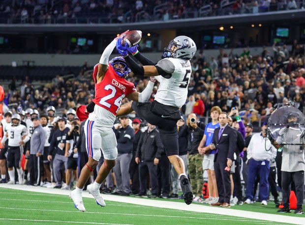 More up-for-grabs action in the first half as Westlake's Denim Collins (24) contends with Guyer's Jace Wilson.