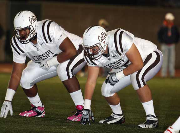 Uncommitted star guard Jordan Simmons of Crespi (Encino, Calif.) is lined up next to teammate Stephen Hutchinson in this photo. The big question about Simmons is which team he will line up with in college — and whether he will wear pink cleats.
