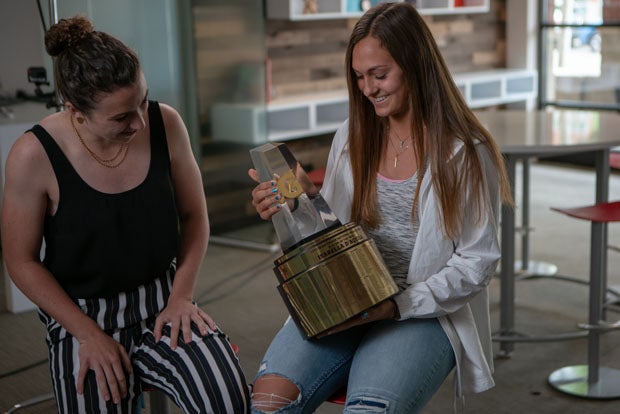 Izzy D'Aquila is given 2017-18 Gatorade National Girls Soccer of the Year trophy by two-time award-winner Morgan Andrews.