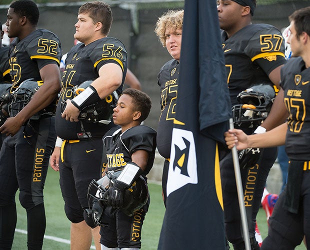 Adam Reed stands with his teammates along the sideline before the kickoff of last Saturday's home game.