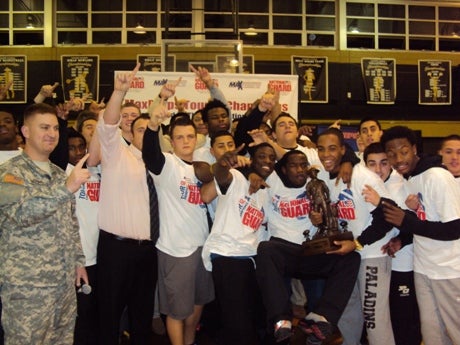 Paramus Catholic players celebrate after receiving the Minuteman Trophy during a ceremony at their school.