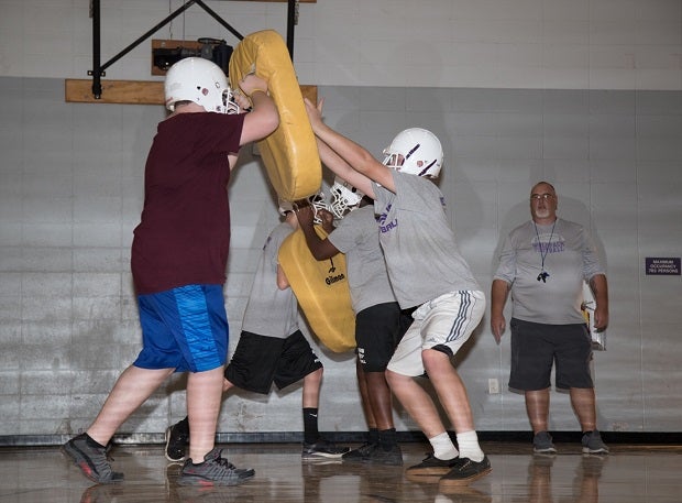 While Shasta freshman football players work on technique, several on the squad have lost homes in the Carr Fire.
