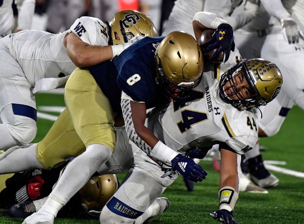 Central Catholic defensive end Jason Harden (8) with a big stick on Aiden Taylor.