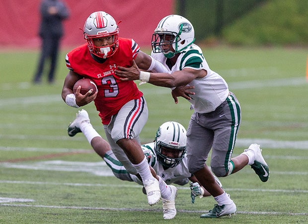 St. John's running back Ron Cook Jr. attempts to elude two Central defenders.