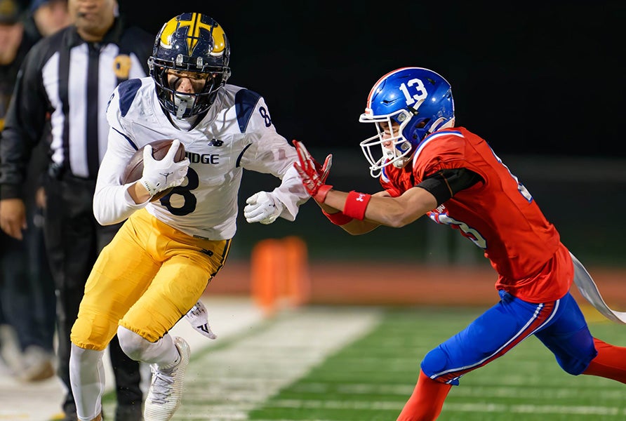 Oak Ridge's Jack Granrud and Folsom's Travis Beatty meet down the sideline during the 2025 Sac-Joaquin Section Division I championship game. The Trojans and Bulldogs will battle Friday in the MaxPreps Game of the Week Presented By T-Mobile. (FILE PHOTO: Mark Nunez)