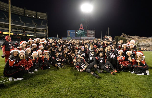 Centennial players and cheerleaders pose for a group shot following the game at Angel Stadium.