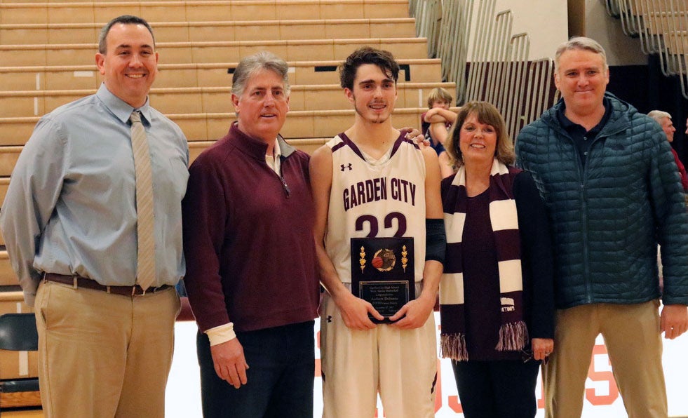 Andrew DeSantis is flanked by family and Garden City officials after he broke the career scoring record at the school.