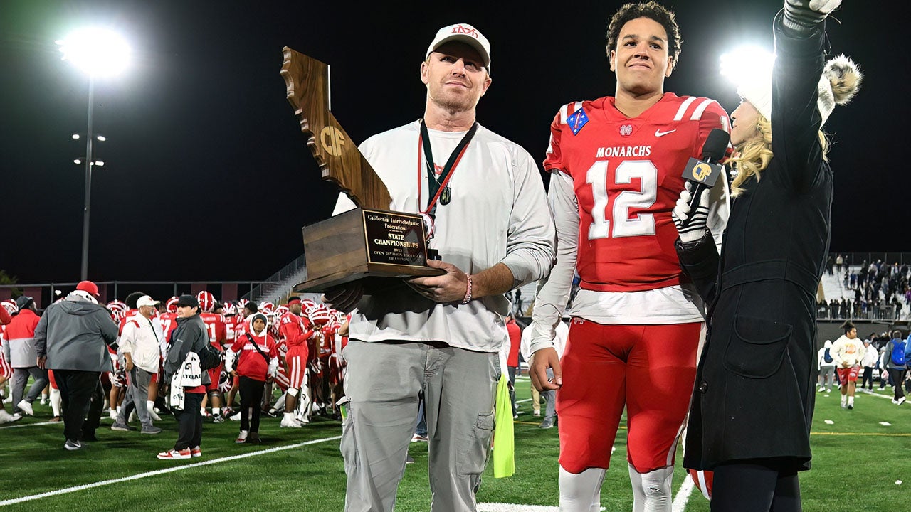 Frank McManus accepts the state championship trophy in December alongside star quarterback Elijah Brown following a 35-0 thrashing of Serra in the title game. (Photo: Heston Quan)
