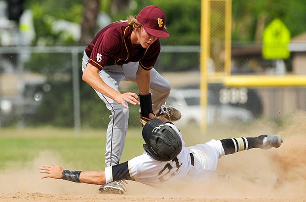 Charles Minderhout of Heritage Christian (Calif.) is tagged out in a cloud of dust at second base by a Valley Christian player.