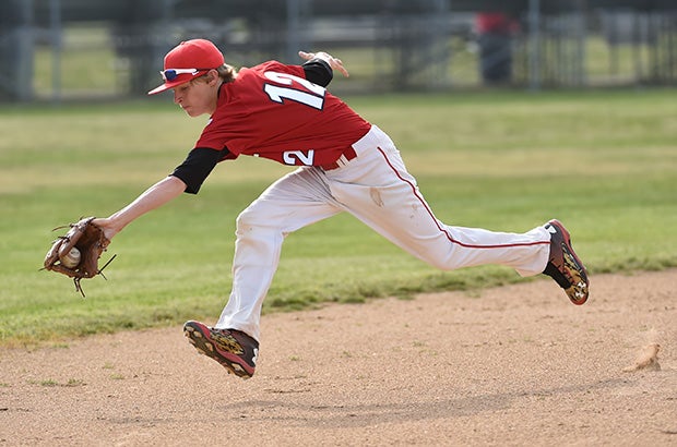 A Laurel (Del.) shortstop stretches to make a stop on a ground ball during a game against Delmar.