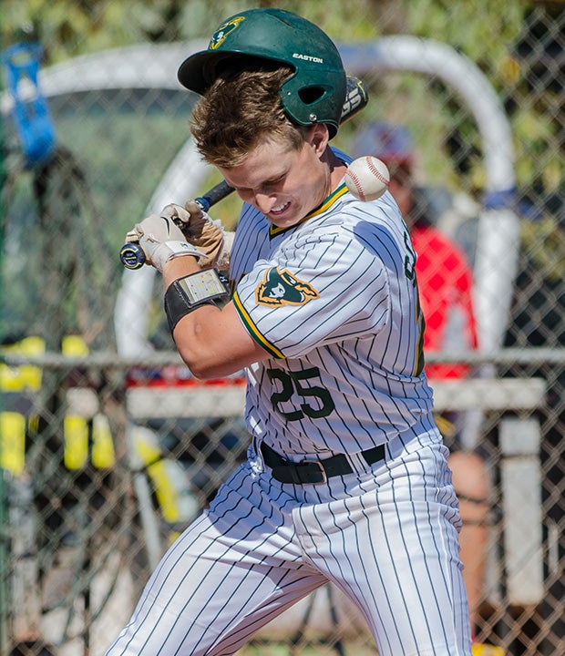 Eric Schaefer of Moorpark (Calif.) gets hit by a high pitch against Sandia Prep (N.M.) during a game in the Coach Bob National Invitational in Arizona.