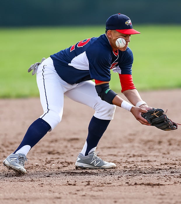 An American (Calif.) infielder takes a ball off his face while attempting to field a grounder during a game against Kennedy.