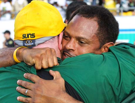 University head coach Roger Harriott receives a congratulatory hug following his team's victory in the Florida 3A state championship game on Saturday.