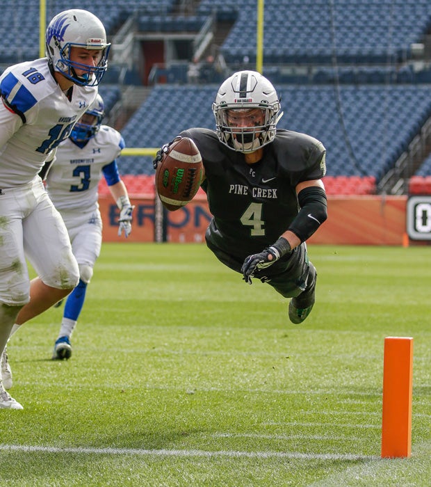 Peter Isais of Pine Creek (Colo.) dives into the end for a touchdown during the CHSAA 4A state title game against Broomfield at Sports Authority Field in Denver.