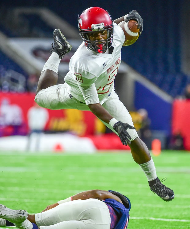 North Shore (Texas) running back Kerrion Hadnot hurdles over an Atascocita defender during the UIL 6A Division I Region III title game at NRG Stadium in Houston.