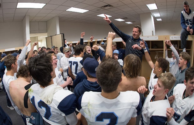 Valor Christian (Colo.) head coach Rod Sherman celebrates with his team in the locker room following their victory over Pomona in the CHSAA 5A state championship game at Sports Authority Field in Denver.