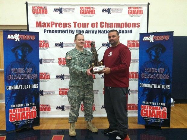 Head coach Michael Palmieri receives the Minuteman Trophy.