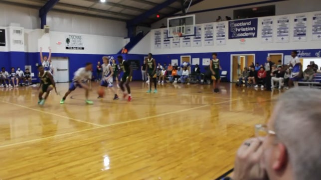 Leland Ramey (11th grade) takes the ball up court, snaps two defenders ankles then drives and does an insane up and under layup in midair through two more defenders.