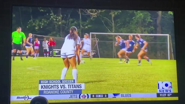 Scottie is number 14 in white jersey going through multiple defenders to score a goal against Hidden Valley.