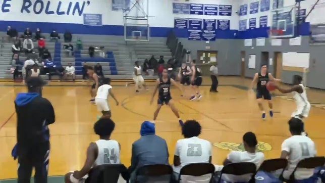 The team passes around for E'miray Fletcher#14 to finish with the floater.