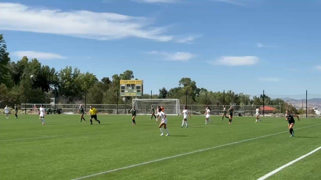 The North Valleys goal keep blocks Caitlin Quigley's first shot, but she controls the rebound and scores the first goal of the game.