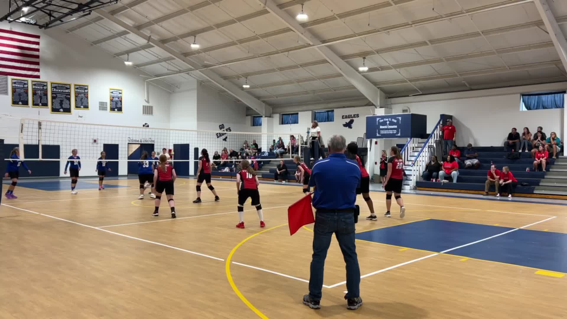 Serve by Emileah Carter (#20) and block by Brooke Arias-Diaz (#9)