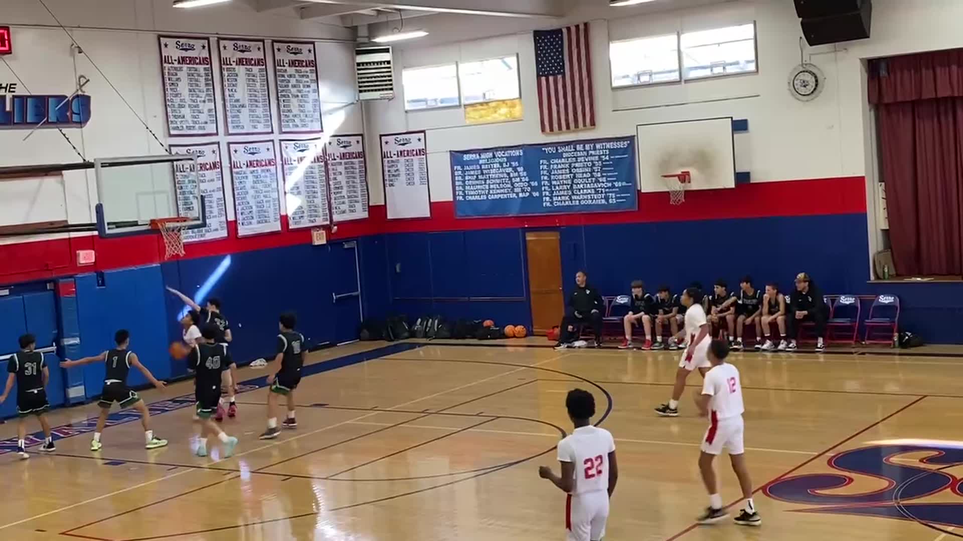 Samuel Smith(#21) finishes at the rim after Dylan Frost flashy pass