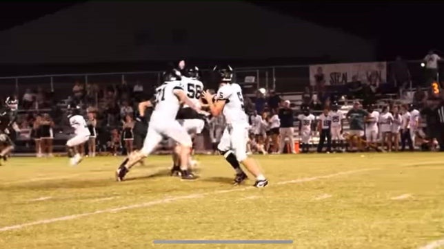 #53 Mason Helton and #56 Guy Murphy work to get a sack against Excel High School.