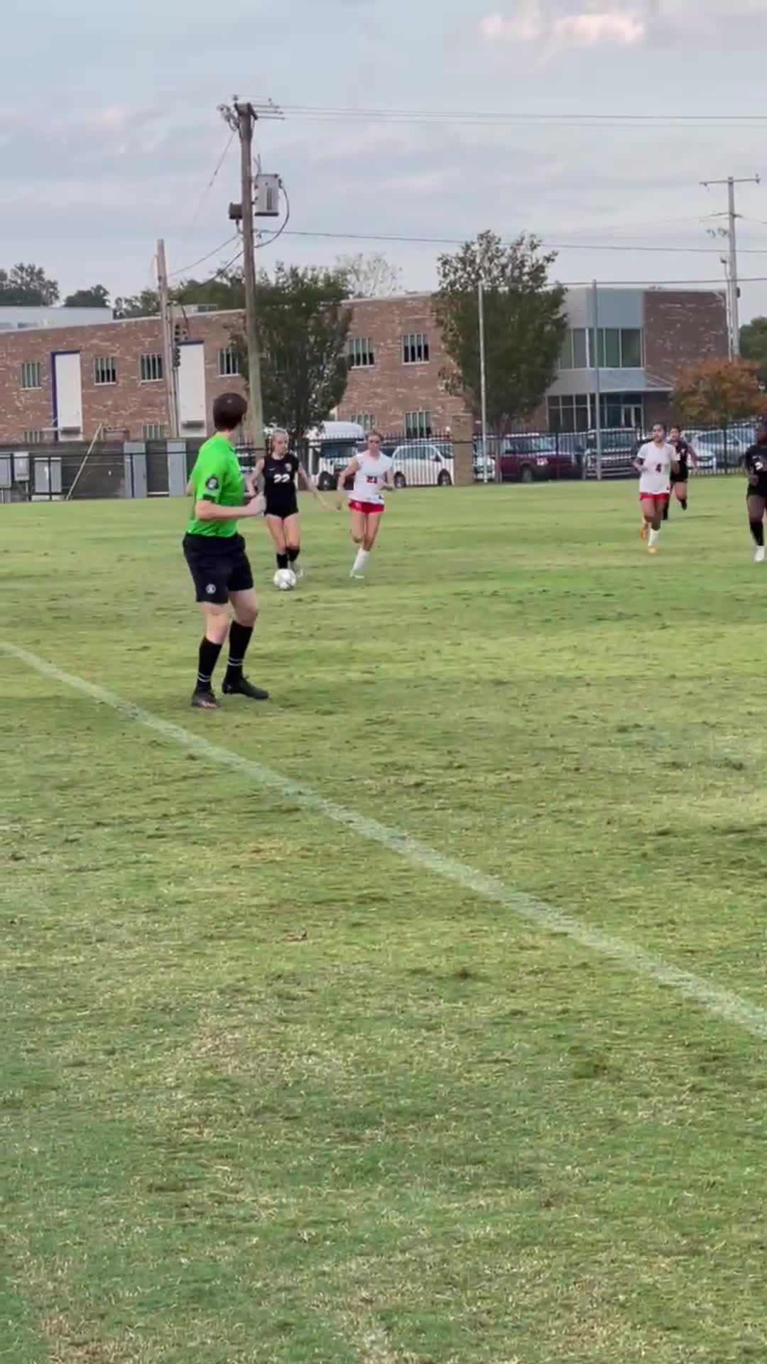 Avery takes the ball from the defensive line down the side. Excellent footwork here as she taps the ball with the outside of her foot, does a bunny hop over the defenders leg, maintains speed and gets down the side for an excellent cross