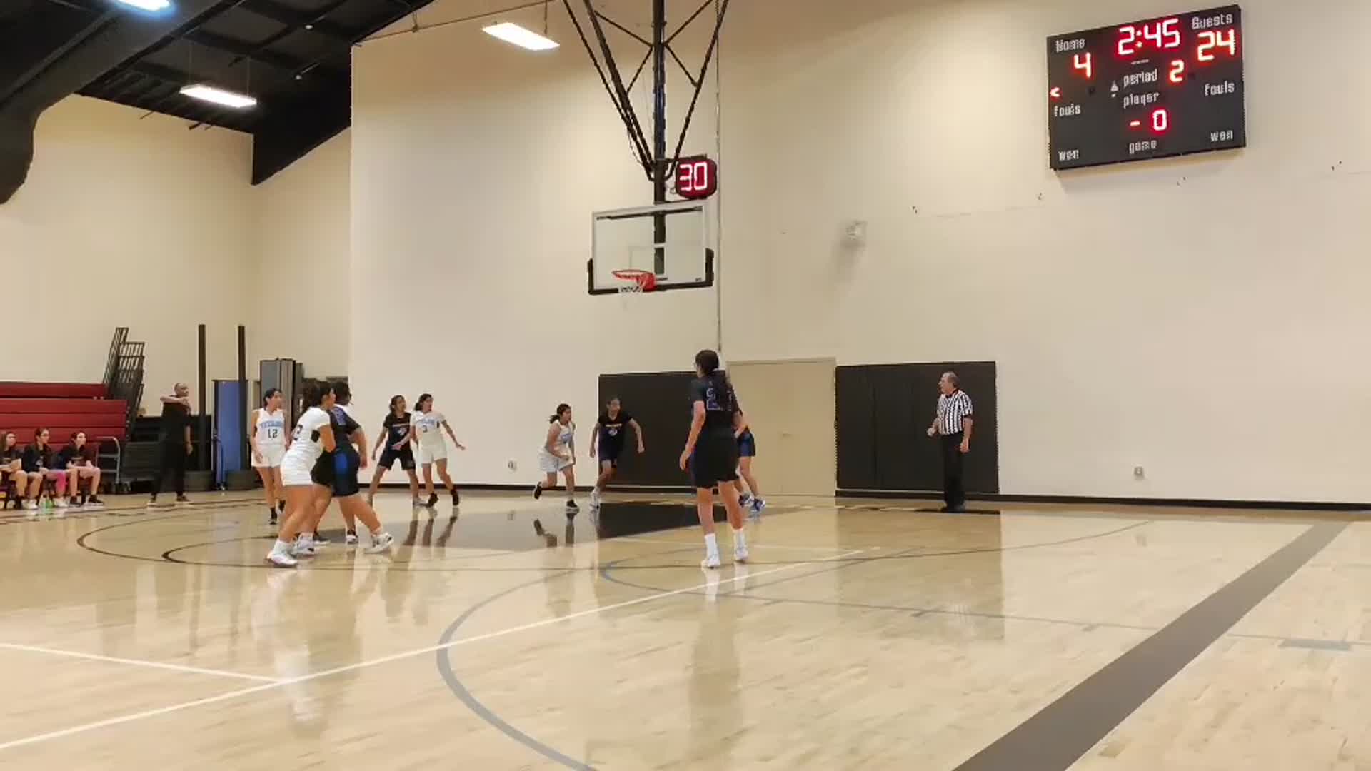Evelyn Quinonez assists Liliana Word for a lay up.