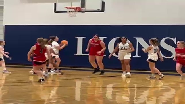 Using a screen from Iliana Rodriguez, Rayne Bookhart nets two of her game-high 20 points in the win over Raleigh Charter.