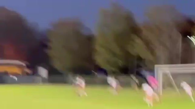 The player sprints down the center of the field and scores with a well-aimed shot into the bottom left corner of the net.