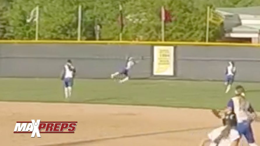 Carmel's (IN) Celene Funke makes an amazing grab in right-center field.