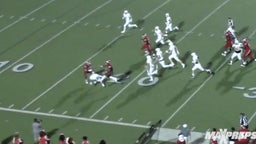 Texas recruit dodging one defender and then hurdling the next