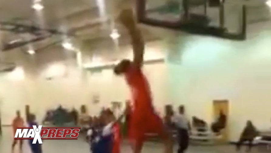 Ashlyn Watkins dunks it on a 9-foot hoop in a South Carolina all-star game.