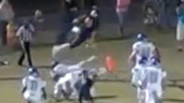 Junior Hunter Hart hurdles over his defenders in the end zone for touchdown