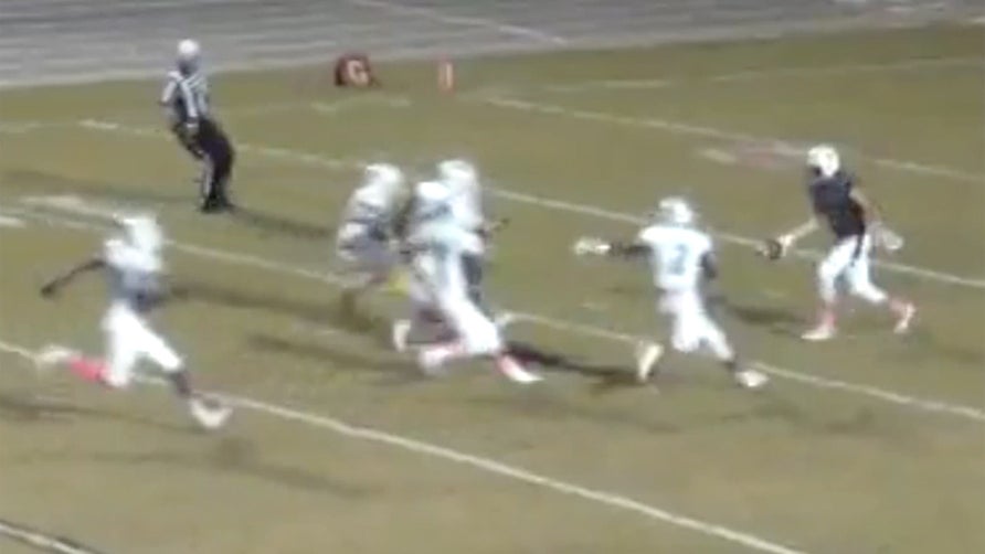 Punter just gets the ball off amongst pressure from five opposing players.  Ball goes into teammates hands who then turns it up field and into a TD.